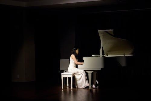 Free Woman Playing Grand Piano Stock Photo