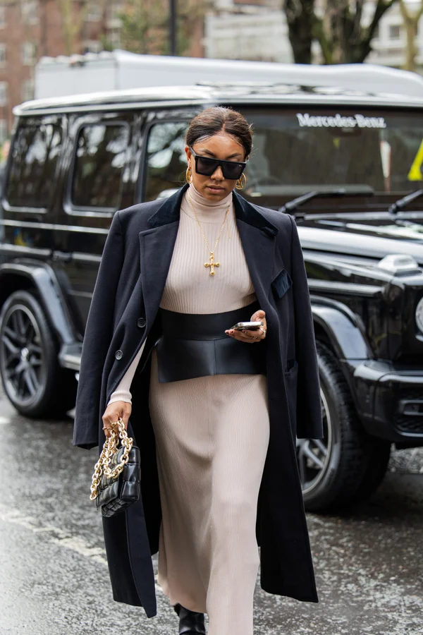 Picture showing an attendee looking gorgeous in a dress and coats for the fashion week