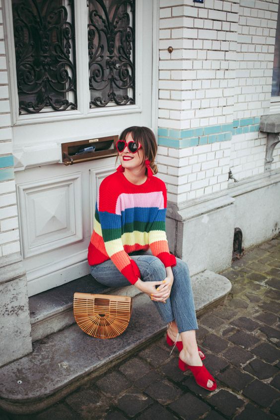 A colorful sweater and jeans are worn on fall days