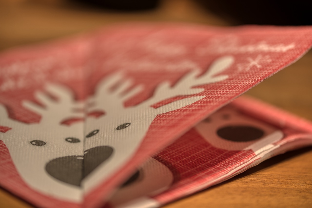 Alt Text: A red napkin with a reindeer’s face on it.