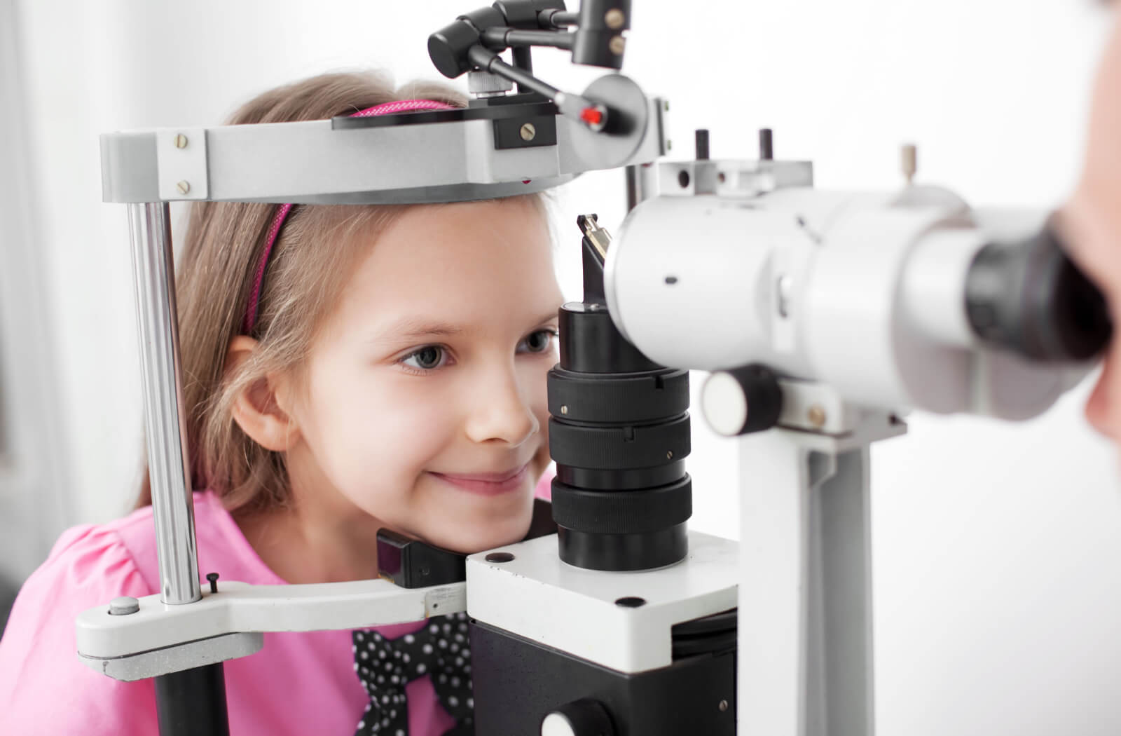 A young girl undergoing an eye exam to determine if MiSight contact lenses.