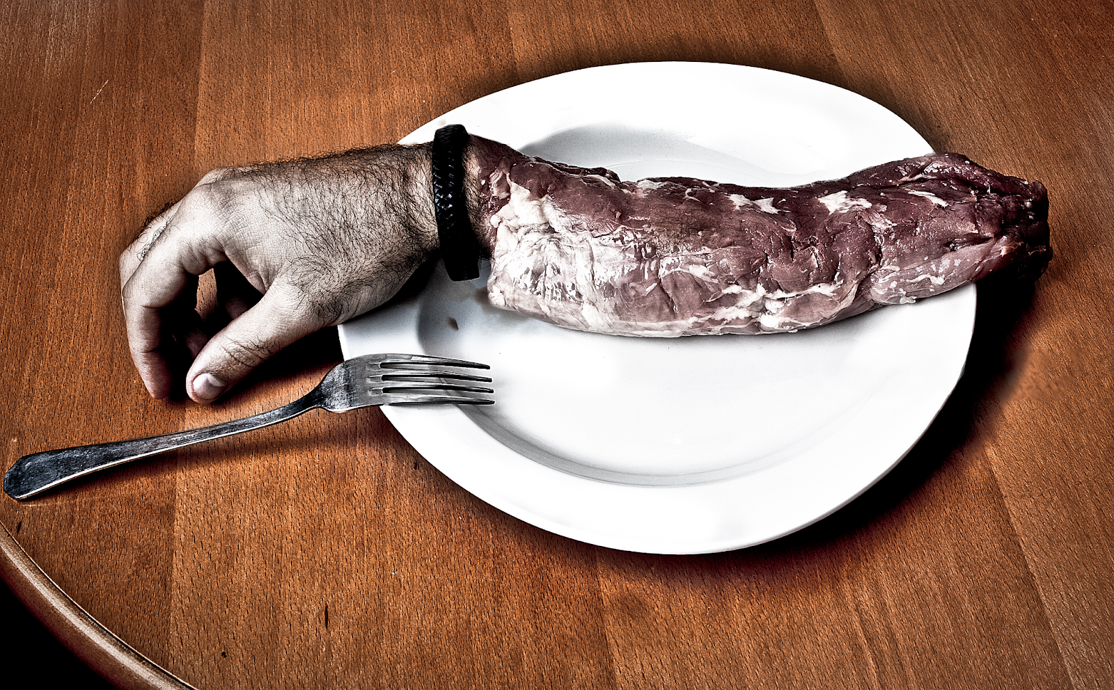 A spooky dinner plate with food resembling a human hand. 