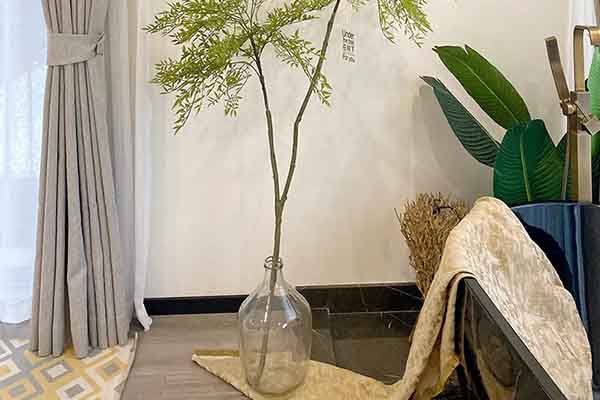 Long stem artificial plant with glass vase