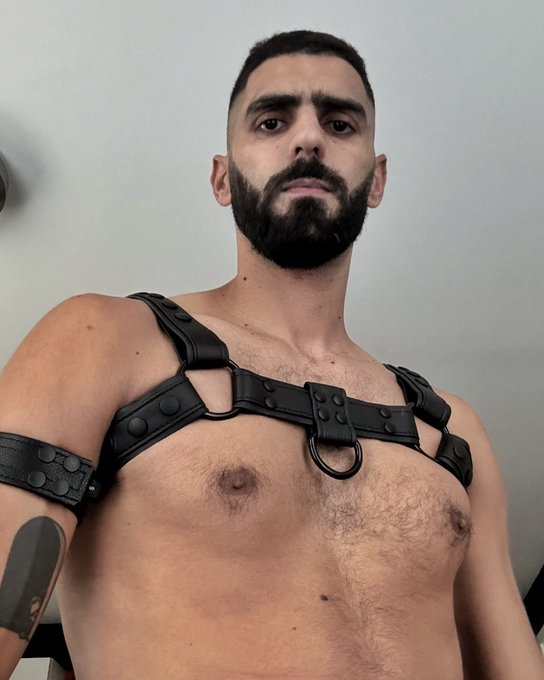 karim yoav taking an iphone selfie wearing a gay leather harness