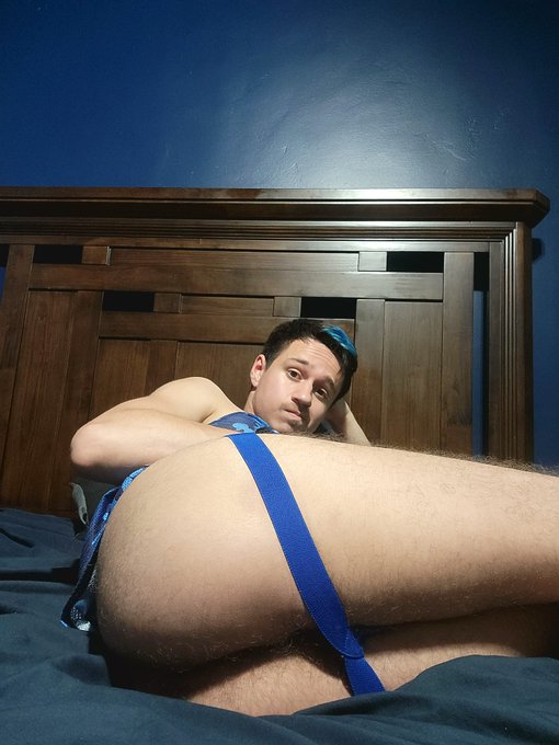 Dakota Wonders sitting on his bed with his ass in the foreground wearing blue camo accessories