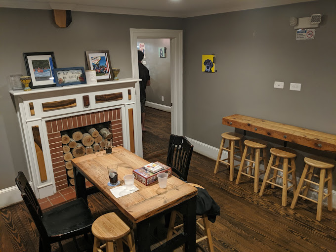 Indoor view of Oak City Brewing with fireplace and casual tables with board games