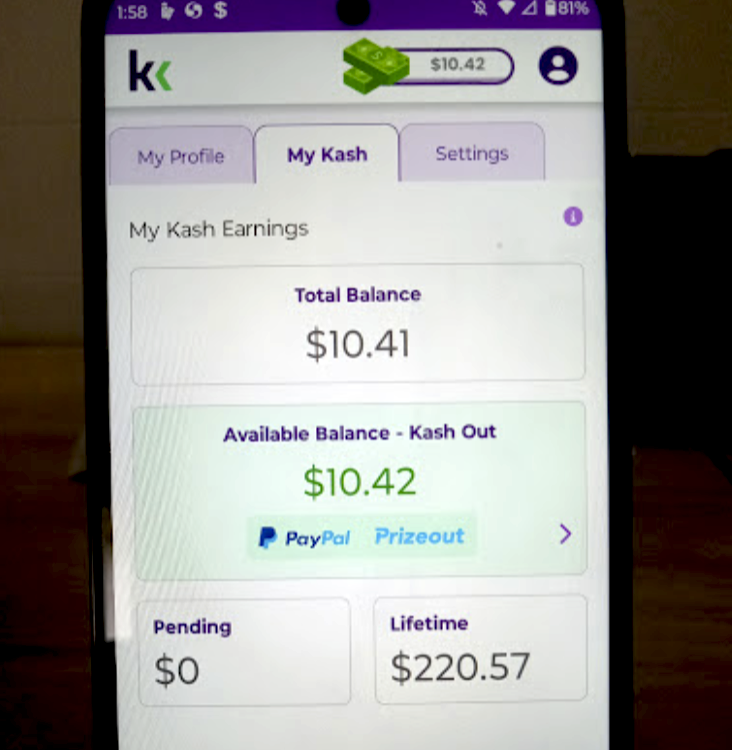 An image of a KashKick user's phone displaying their lifetime earnings of $220.57 on the app and their available balance of $10.42.