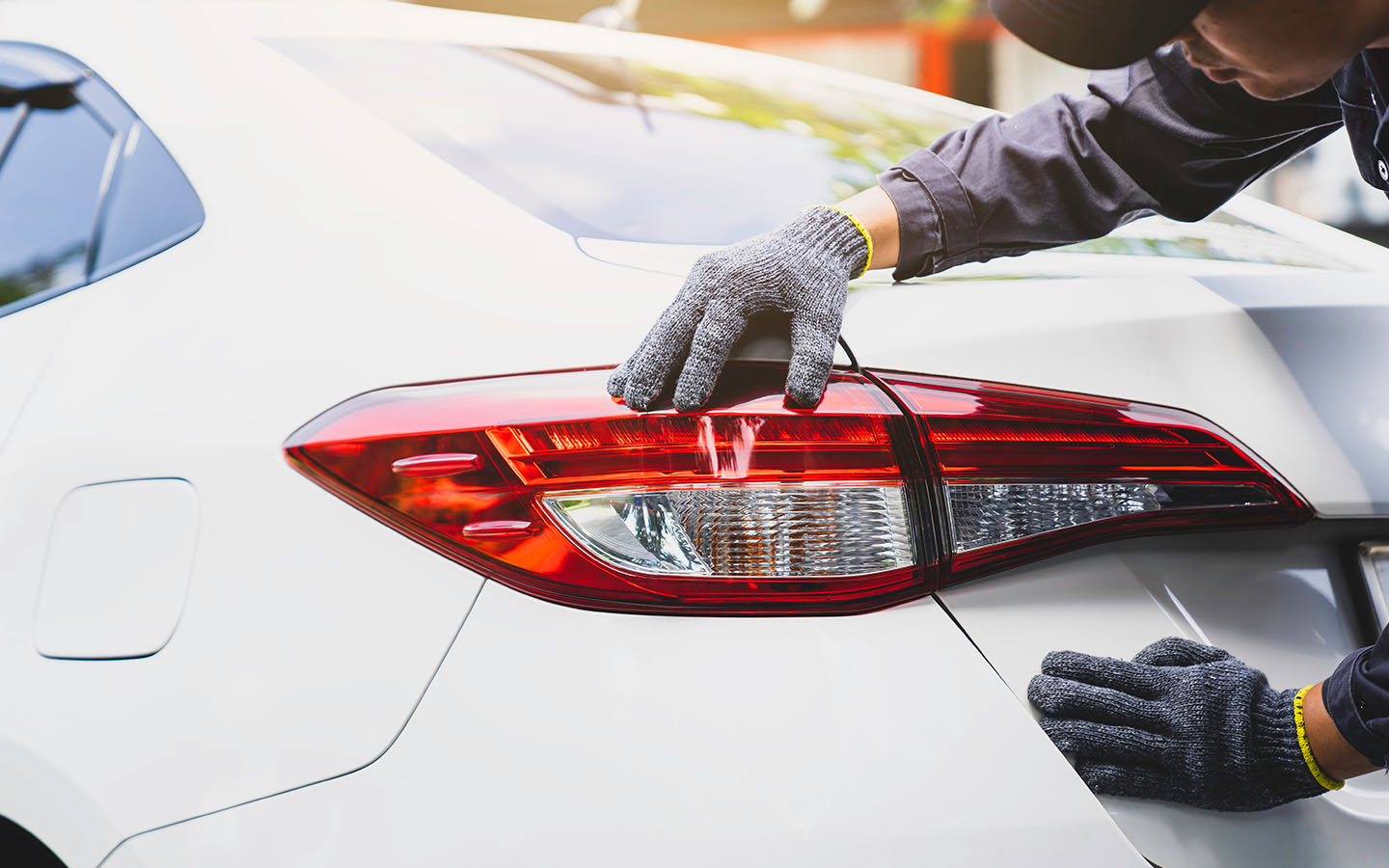 Auto expert inspecting car brake lights