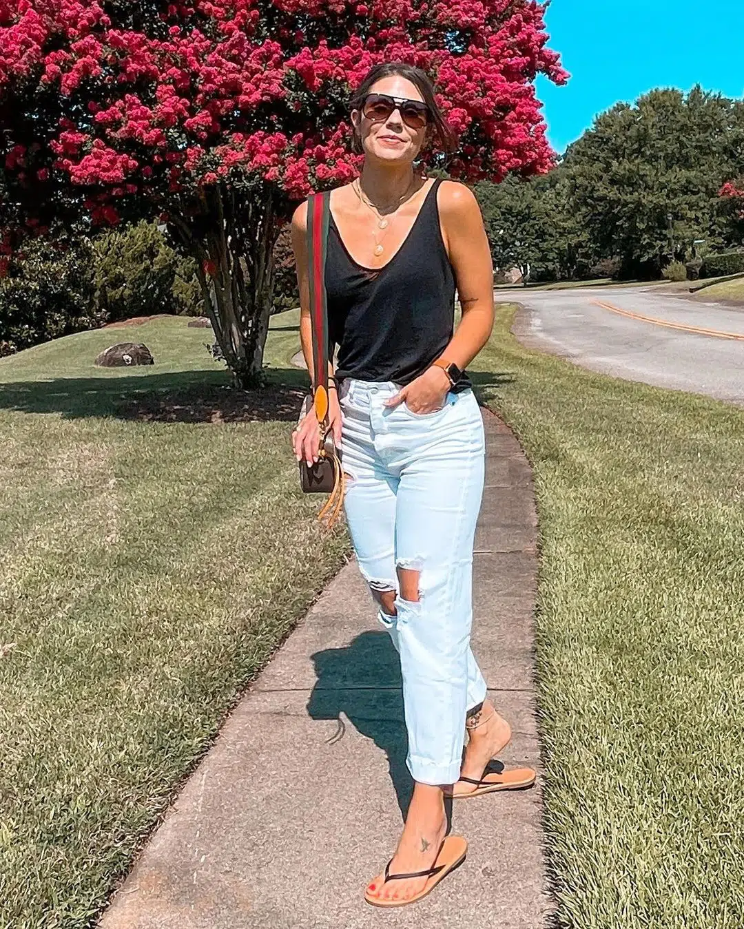 Picture of a lady rocking a mom jean with tan tops and sunglasses to match