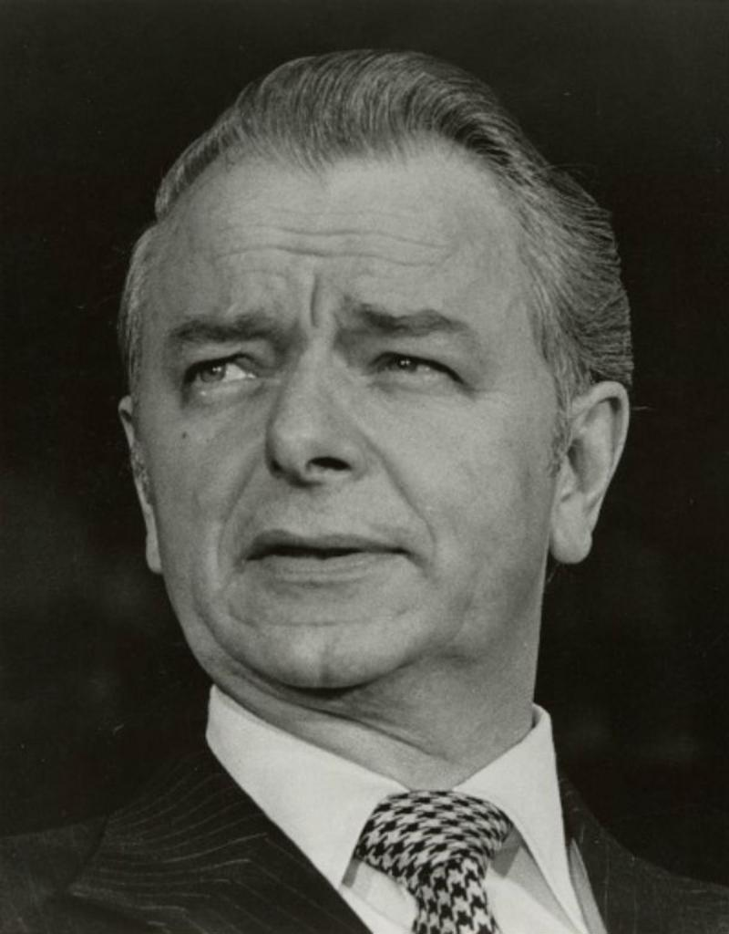 Robert Byrd looks off to his right. He is wearing a suit and tie. He is not smiling. 