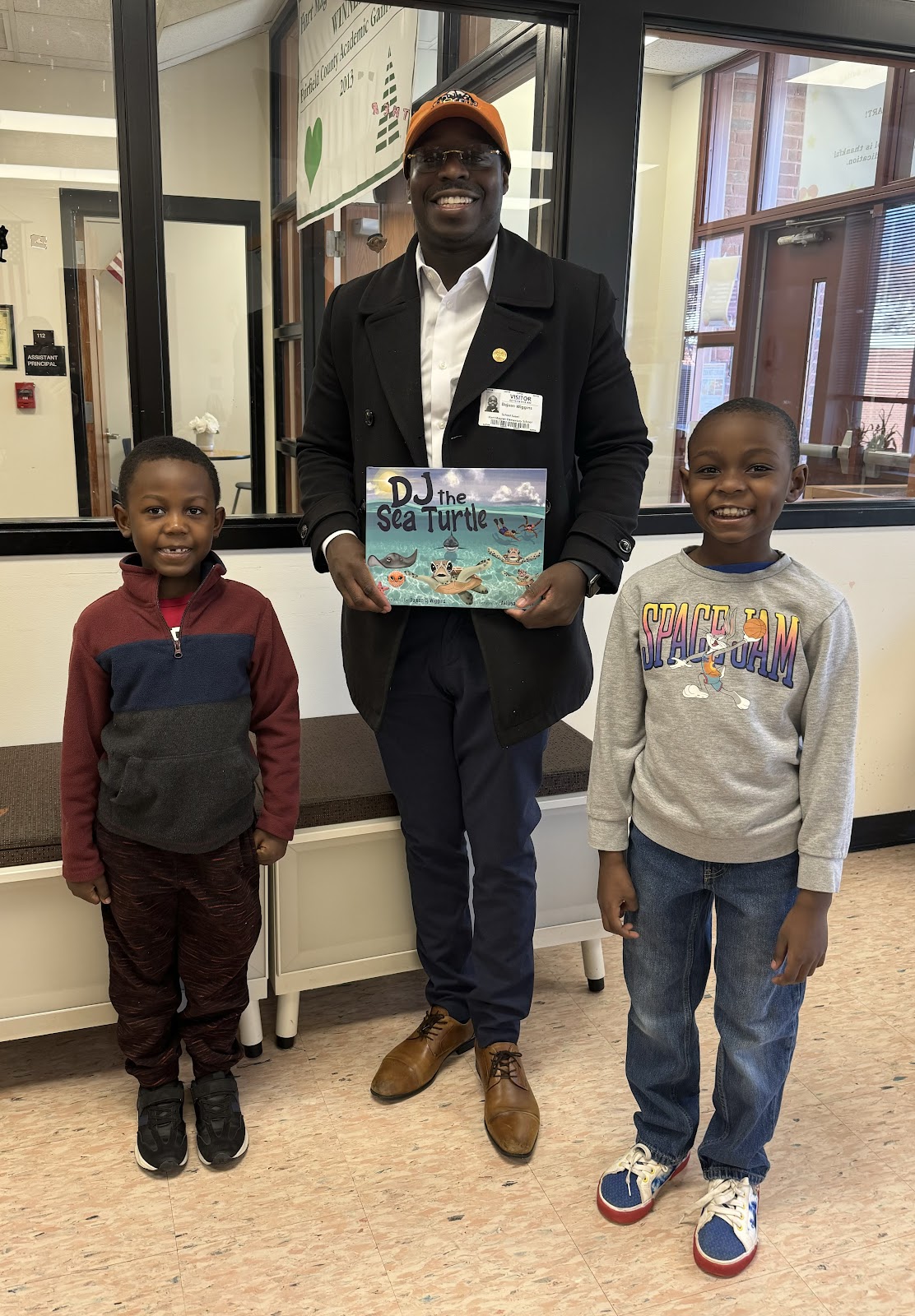 Author Mr. Wiggins with his book DJ the Sea Turtle and two Hart students