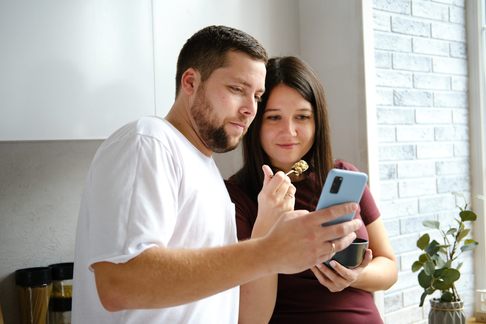 a man and a woman looking at a mobile phone