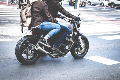 Free Two Person Riding Gray Cafe Racer Stock Photo