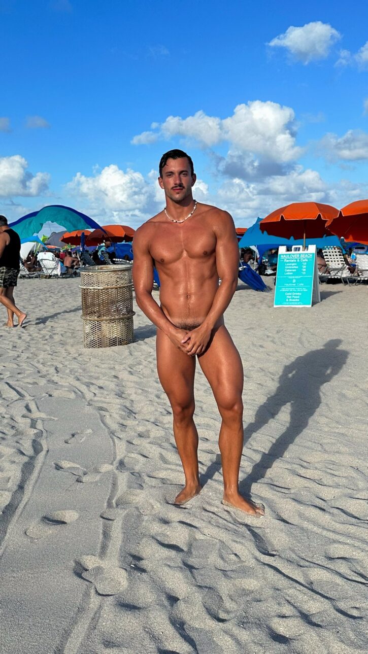 Eric Rmgr naked at the beach placing his hands on his crotch to hide hic flaccid penis