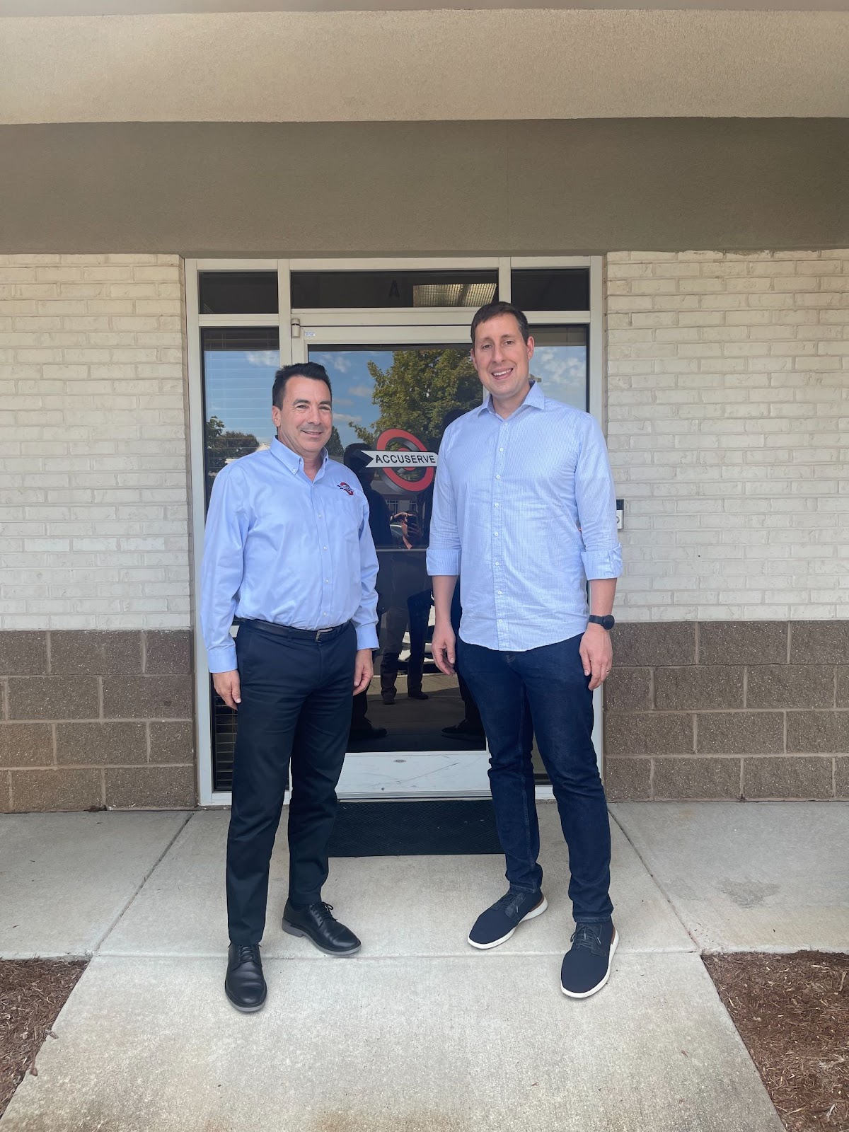 Left to right: Michael Griffith, President of Accuserve, Inc., 
and Jonathan Blanchard, CEO of ETI Precision, outside of Accuserve’s headquarters in Huntersville, NC