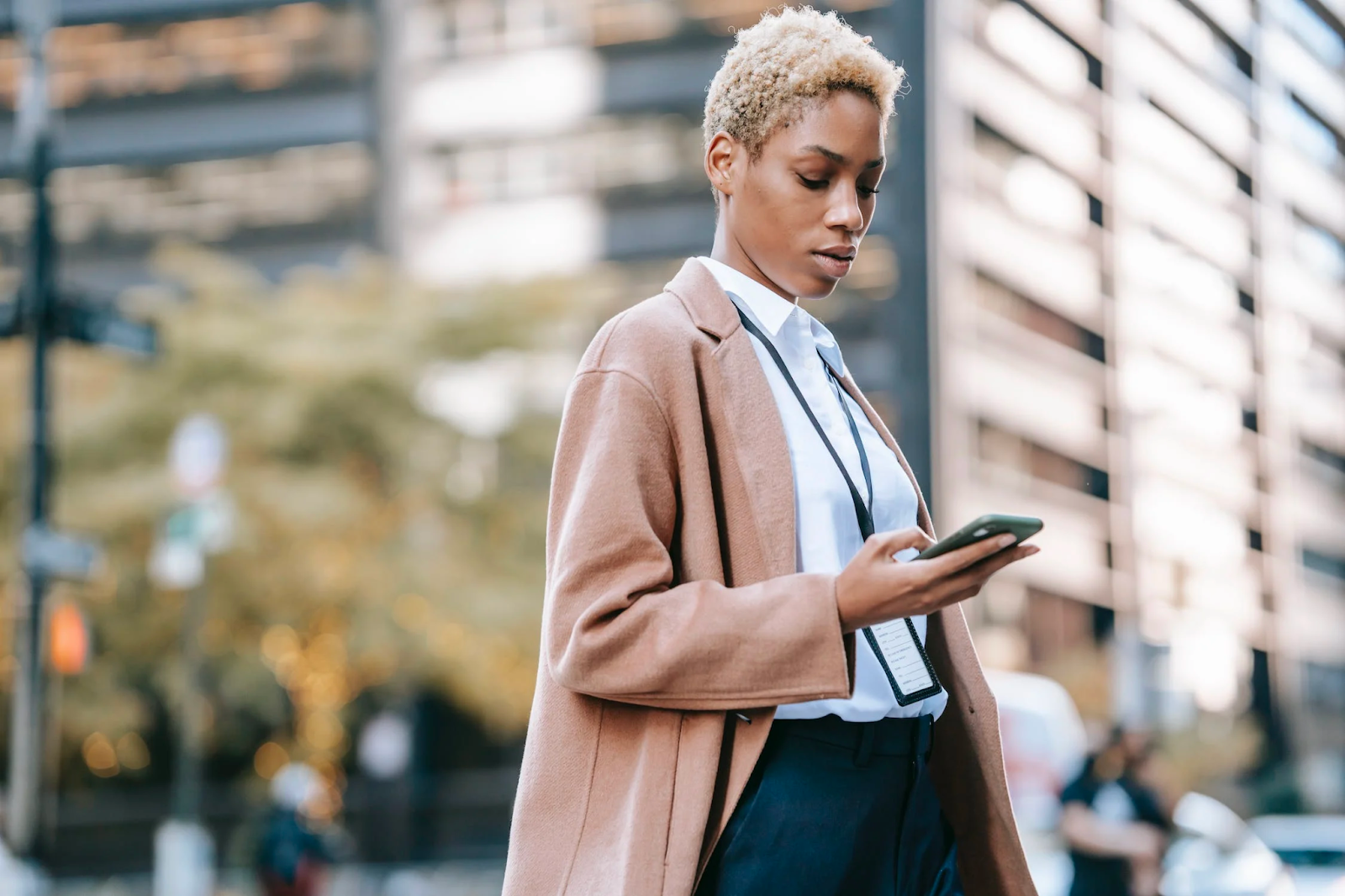  a well dressed woman looking at her phone