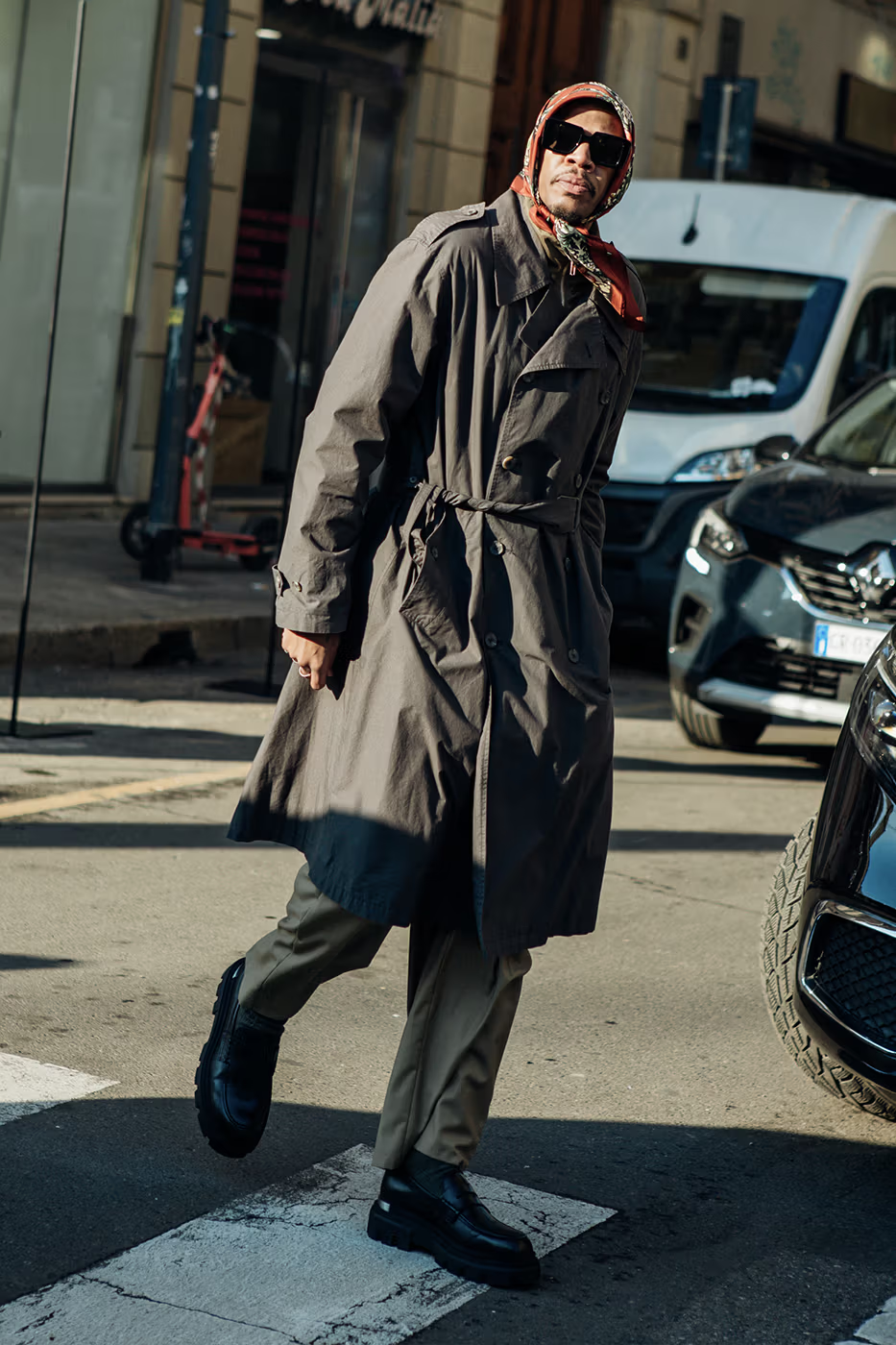 Picture showing a guy with a coat, scarp and shades to accessorize for the Milan Fashion Week Men’s FW24