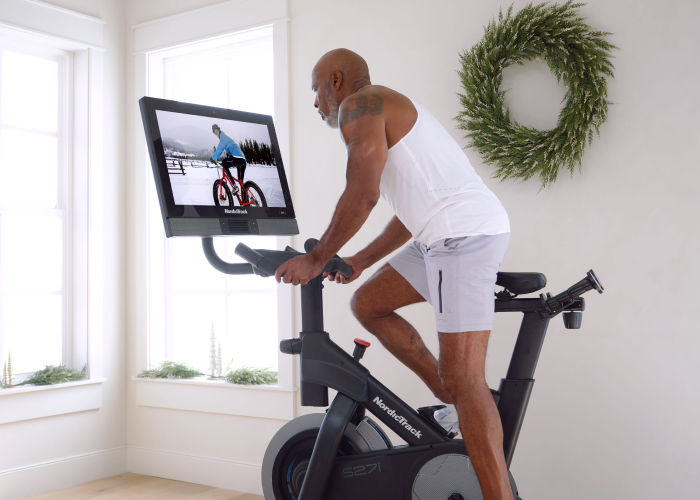 Man Riding NordicTrack Exercise Bike Experiencing the Benefits of Cardio for Longevity