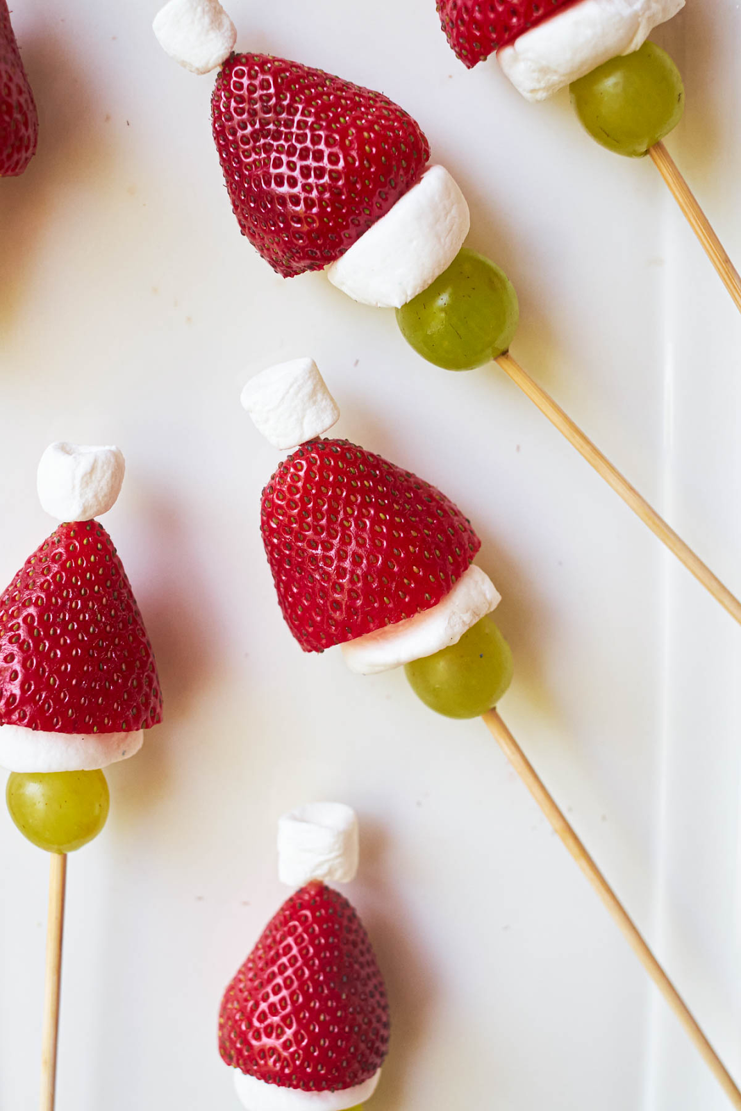 grinch kabobs, strawberries with green grapes and marshmallows