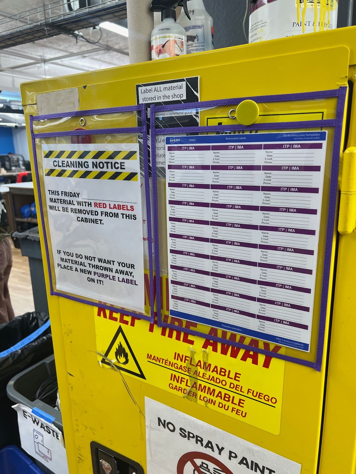 Example: Posted labeling signage and available labels for the current week on the yellow flame cabinet in the Shop