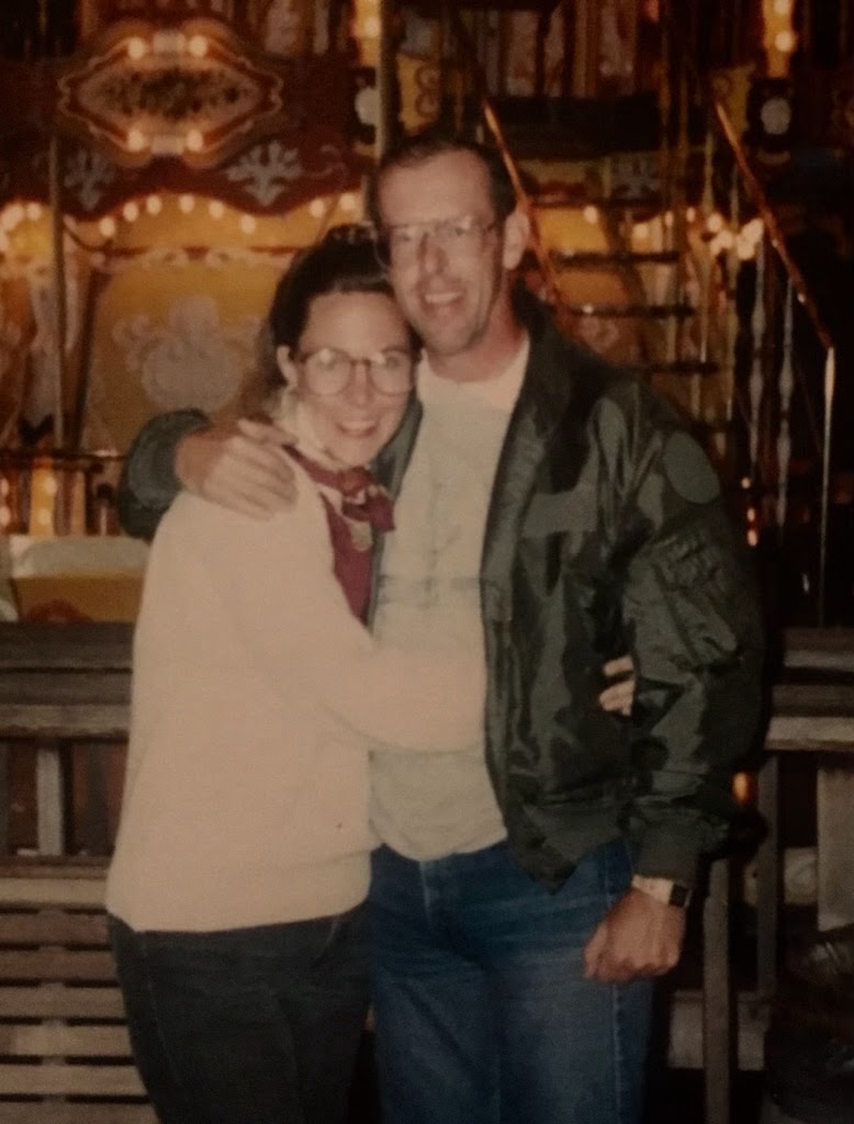 Tom and Bonnie in front of a house with lights