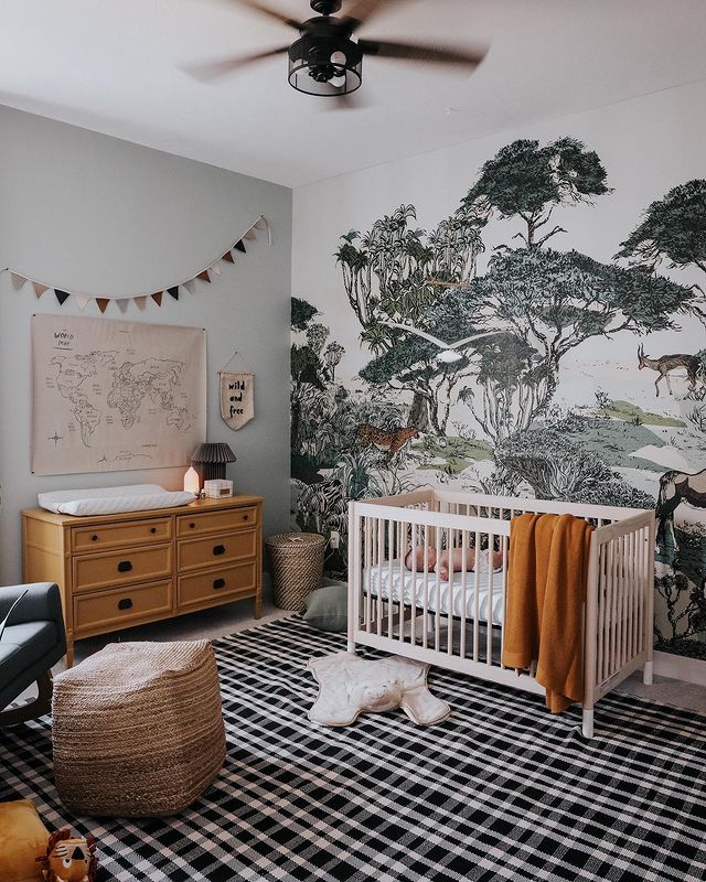 Jungle nursery theme with jungle wallpaper and a vintage drawer set.