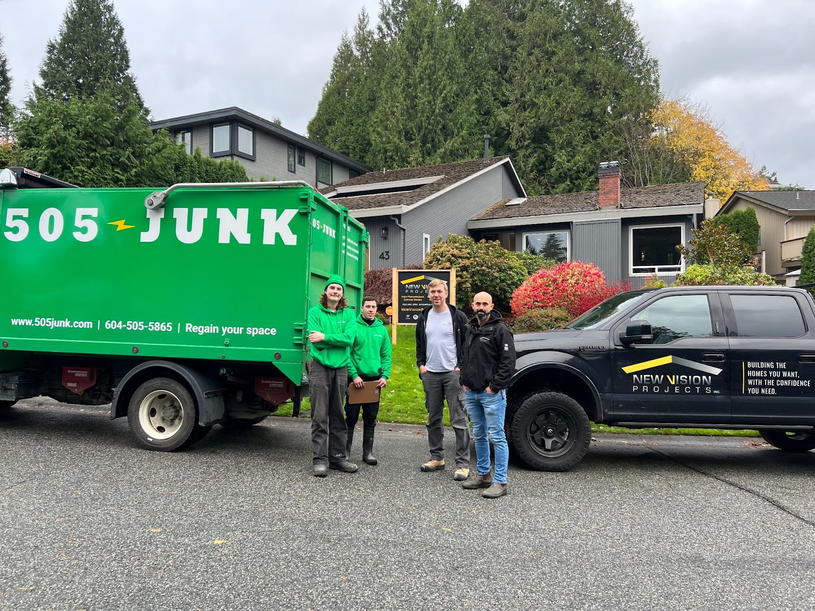Two 505-Junk employees with the New Vision Projects team after completing a junk removal pickup. 