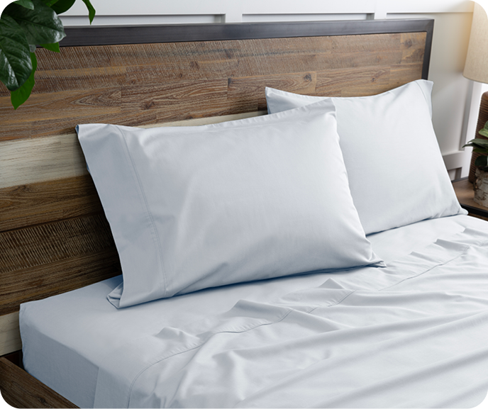Our pale blue Bamboo Cotton Sheet Set in Pearl Blue shown on a bed.