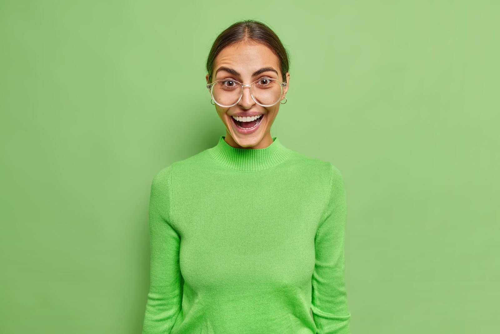 A woman in green shirt laughing.