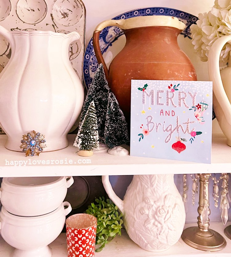 old jugs on a dresser shelf and a christmas card