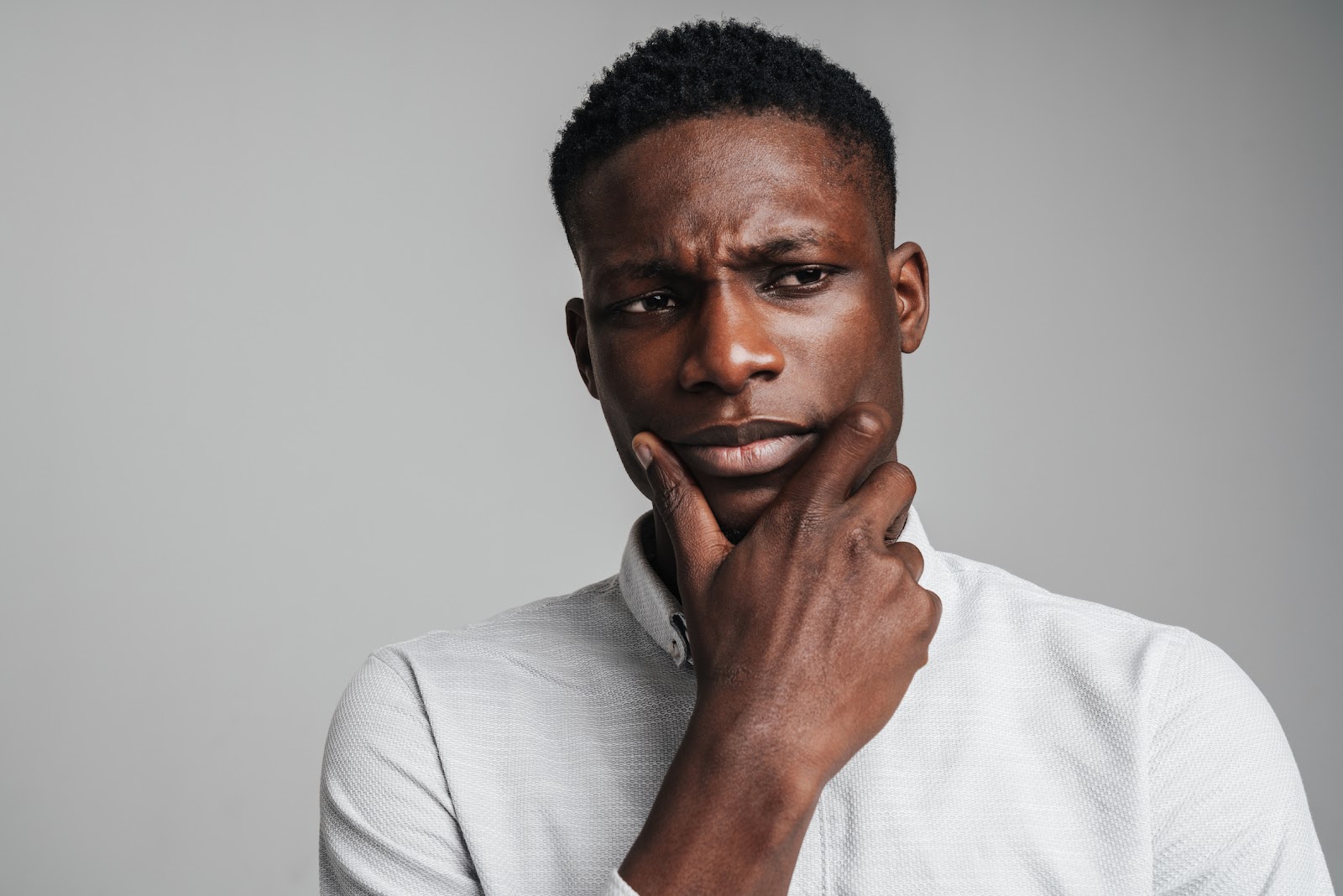 Closeup Portrait of Young African Man Thinking Deeply