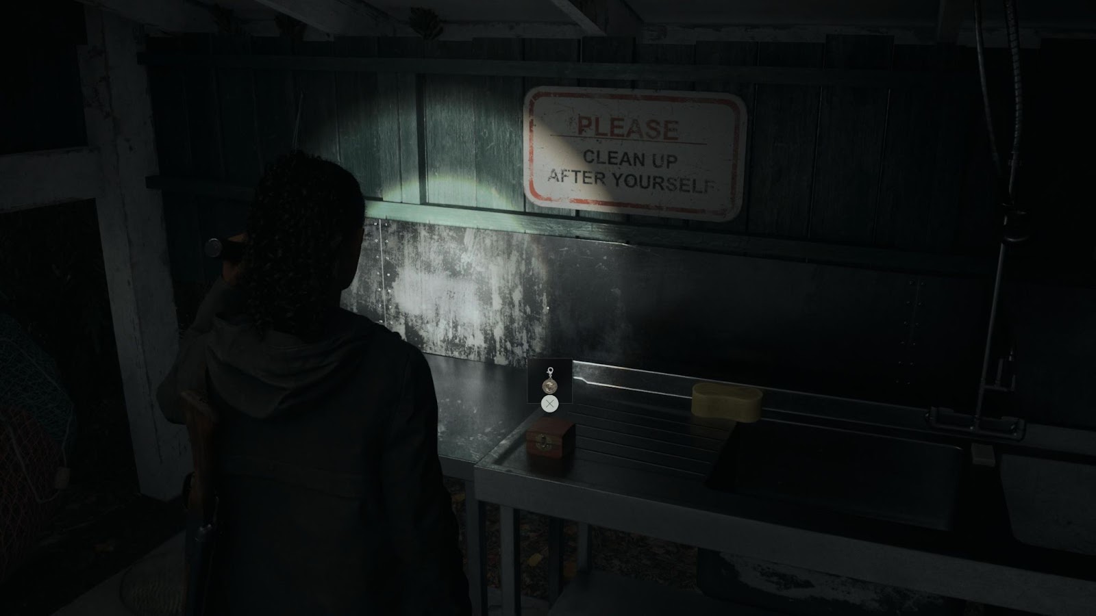 An in game screenshot of the Charm reward that is given from solving the Lighthouse Trailer Park nursery rhyme  in Alan Wake 2. 