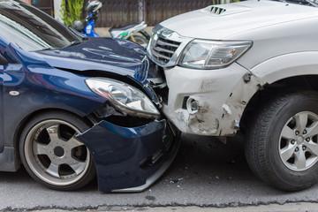 two cars in an accident where they hit head on, side view of damage to each car