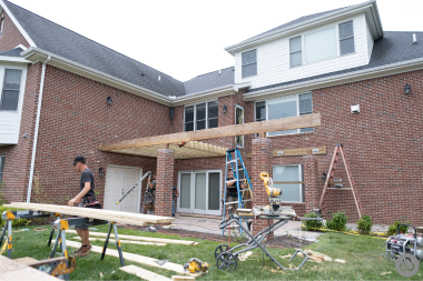 composite deck builders working on new outdoor living space custom built michigan