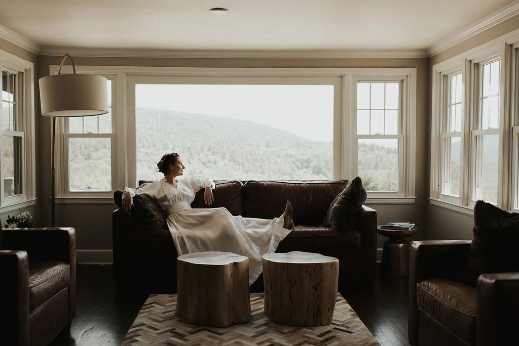 Bride sitting on couch looking out the window
