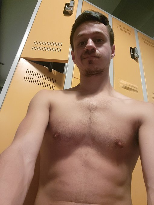 Dakota Wonders taking a selfie from the local bathhouse locker room looking down at the camera