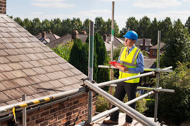Building inspector assesses slate roof condition