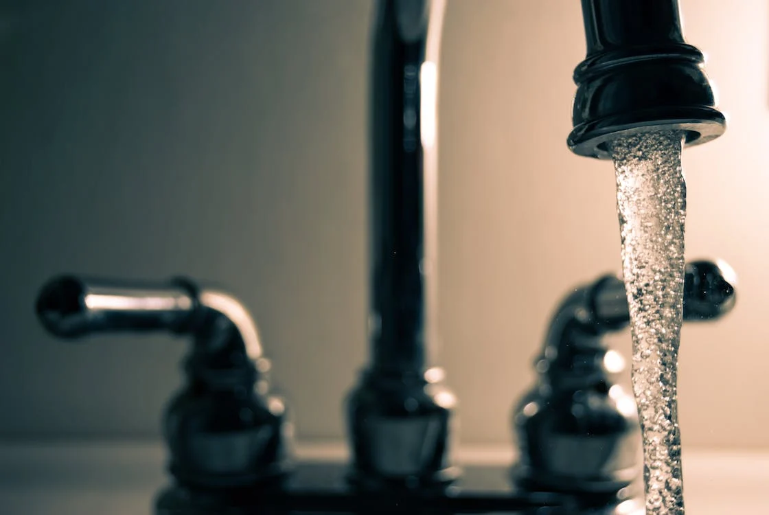 An image of water running down a faucet