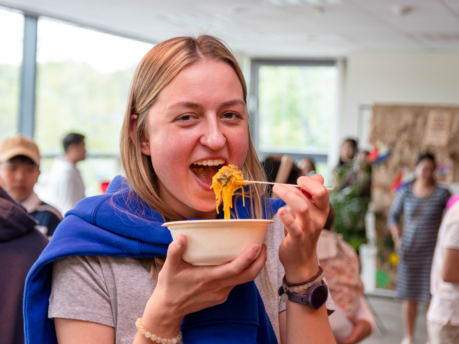 A person eating food with a forkDescription automatically generated