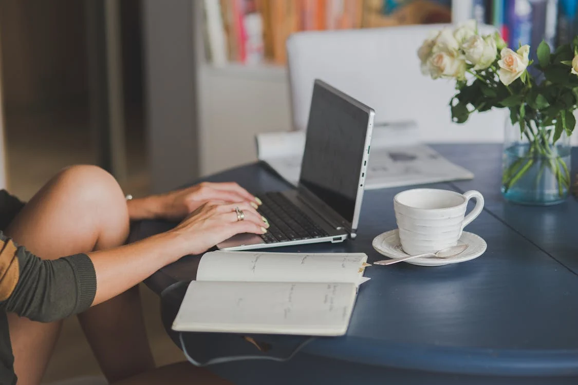 A person using a silver laptop