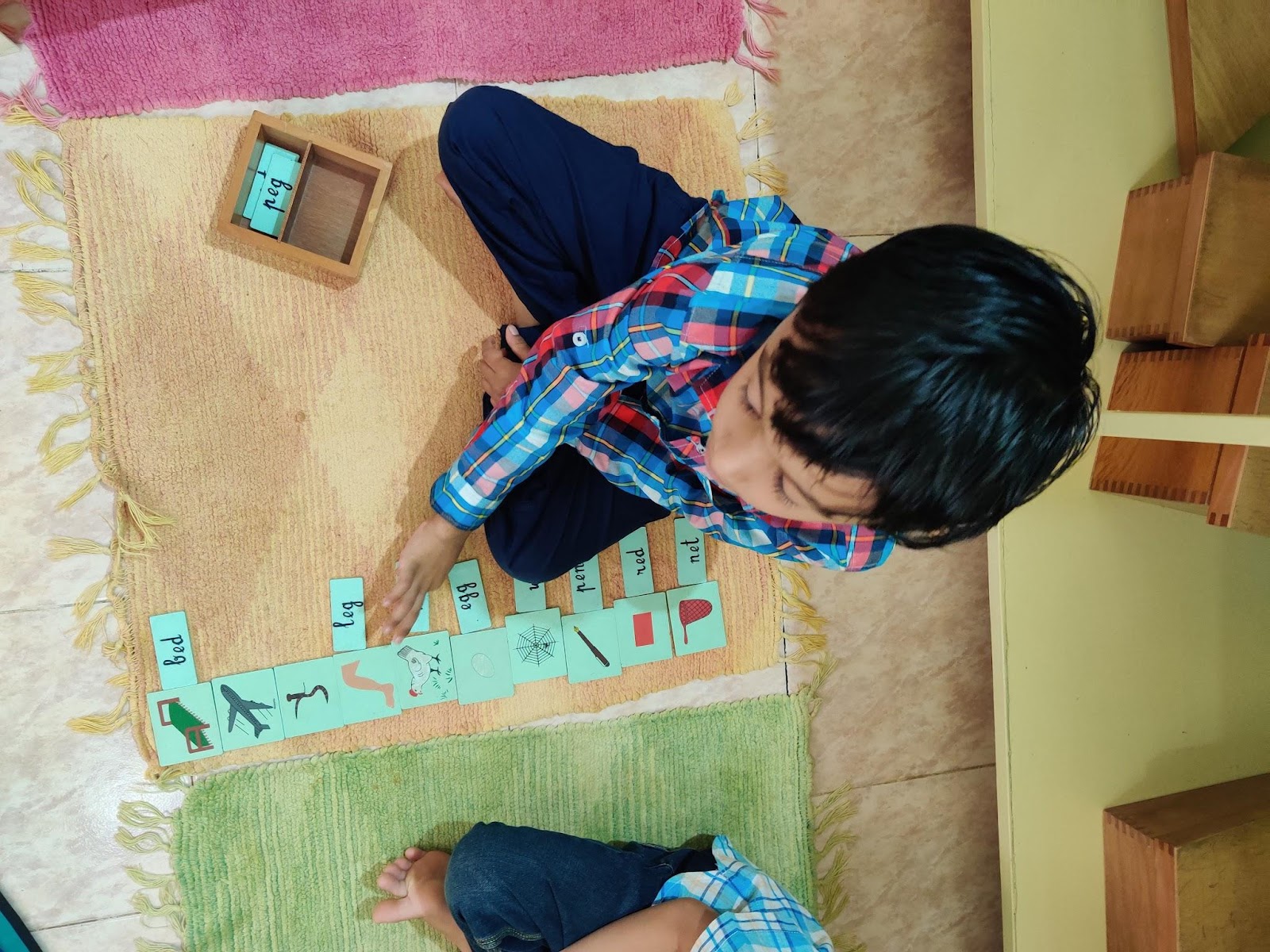 Child playing with images and words