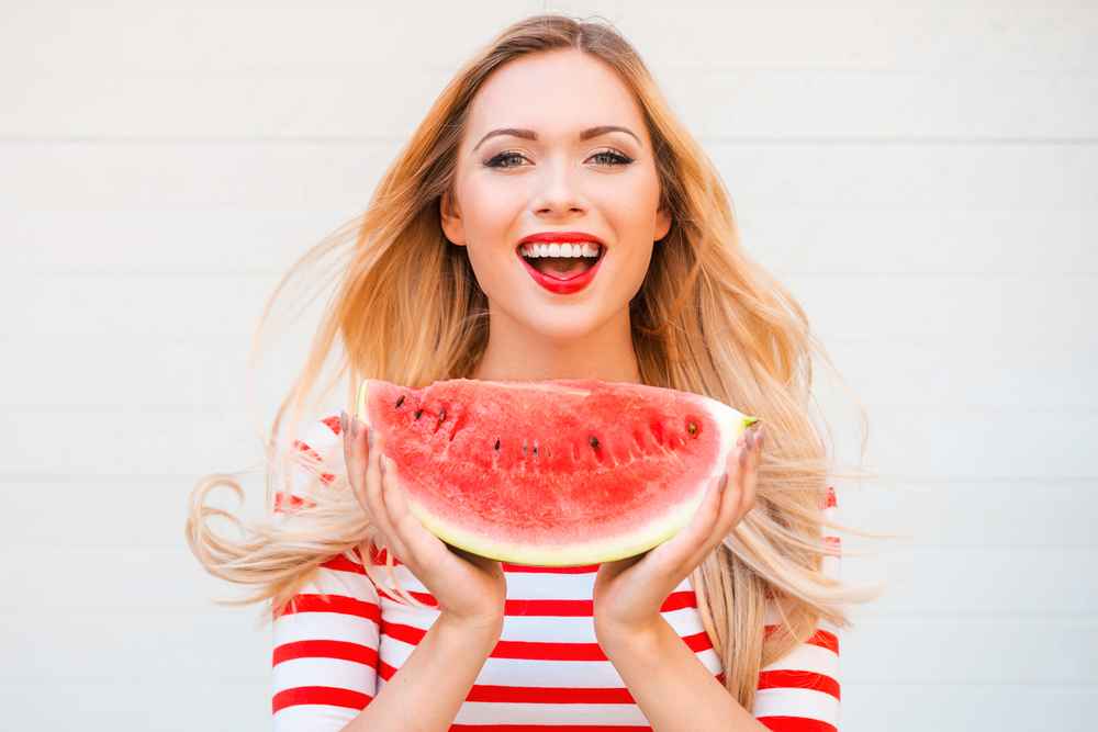 happy women eating watermelon