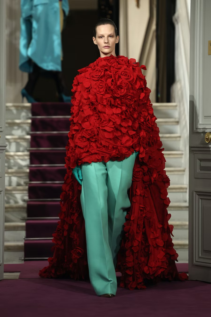 Picture showing a model in dressed in rose flowers for the Valentino show