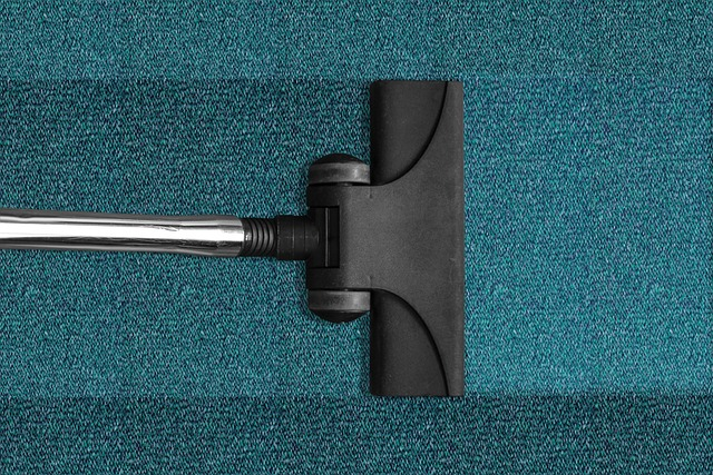 Vacume head of a vacuum cleaner, vacuuming carpet fibers with a dust brush 