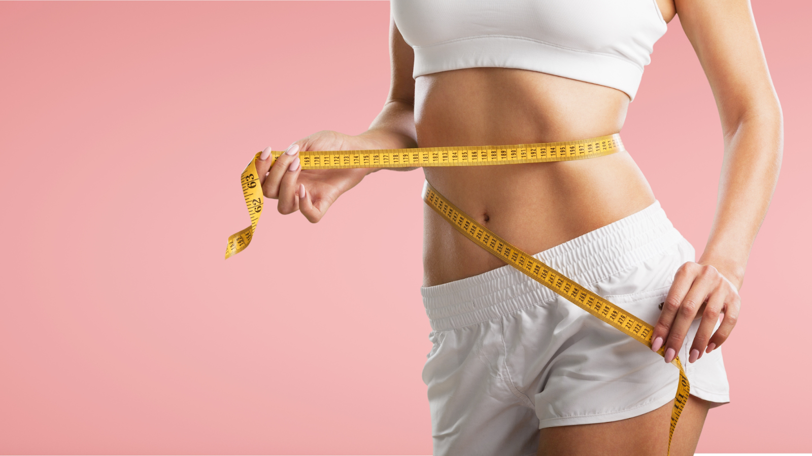 woman measuring waist to help in understanding fat loss