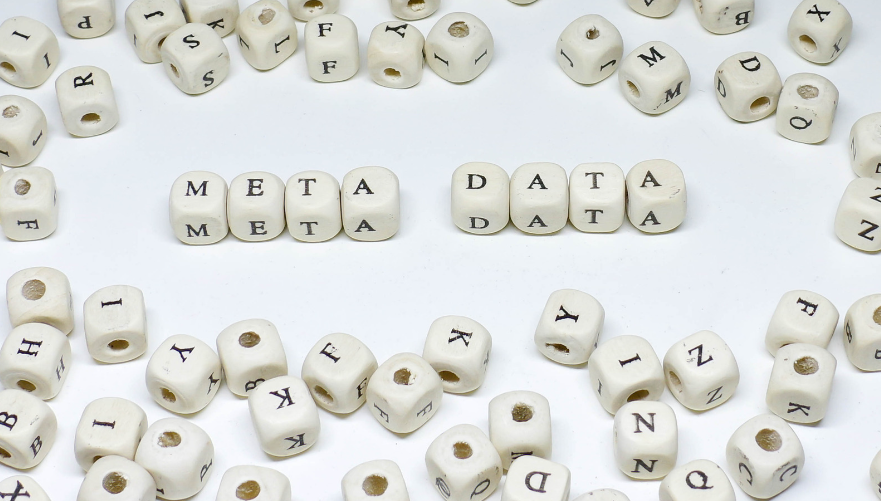 Small wooden blocks spelling out the phrase "meta data."