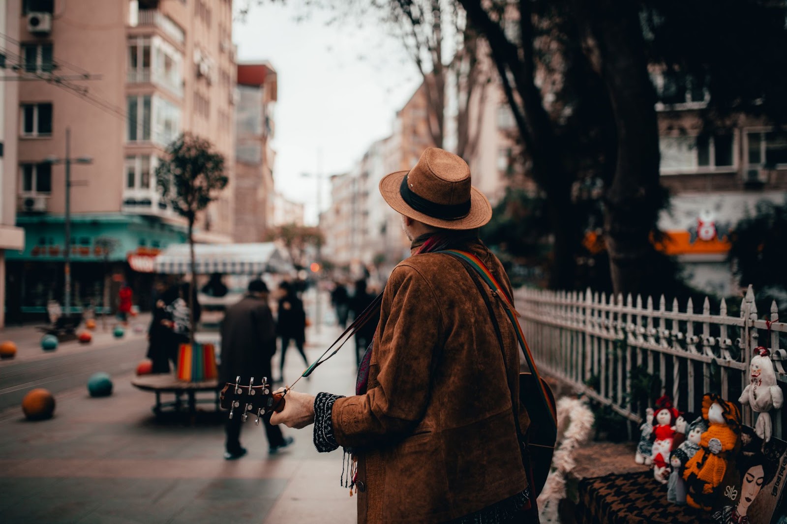 musician playing the guitar live in the streets