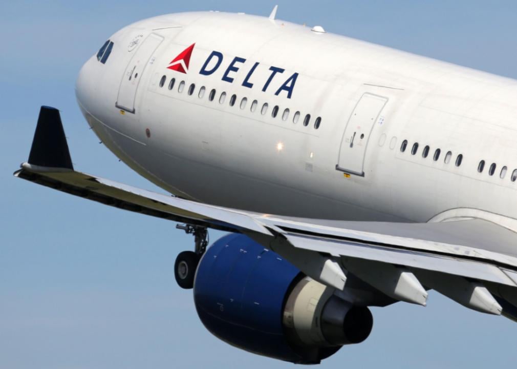 A close-up of a Delta Air Lines airplane in the air. 