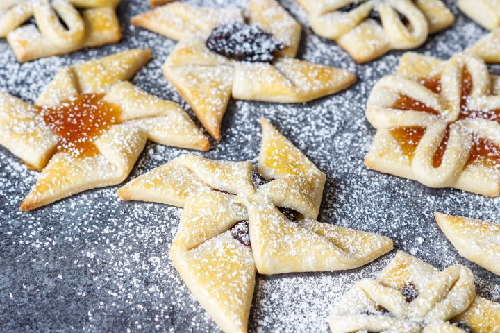 Star and flower shaped Joulutorttu (Finnish Christmas Tarts) covered in powdered sugar.