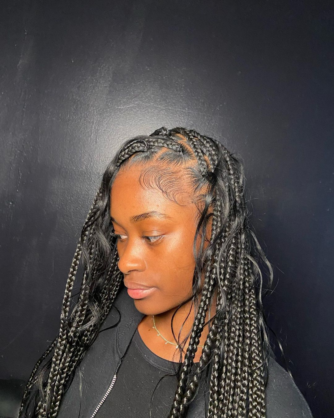 Picture of a lady rocking her loose boho knotless braids  